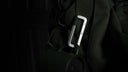 VUUS Zero aerospace aluminum carabiner attached to a backpack, securely carrying essential hiking and climbing accessories on a mountain trail.